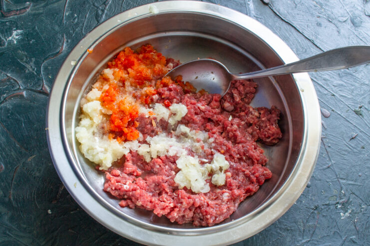 Vegetales en la mezcla Carne molida mezclada con cebolla y pimiento rojo triturados