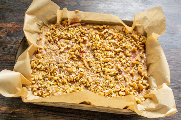 Capa de nueces picadas esparcidas sobre la masa en el molde